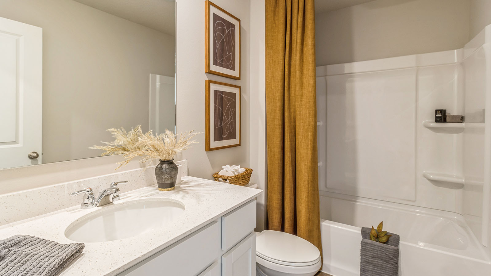 Second bathroom with large mirror and bathtub