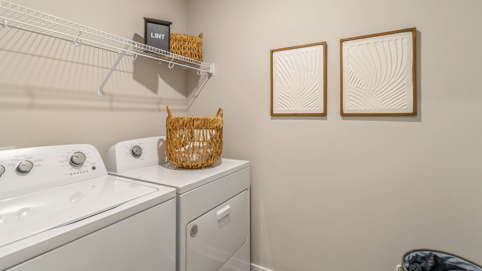 Laundry room with washer and dryer and shelving