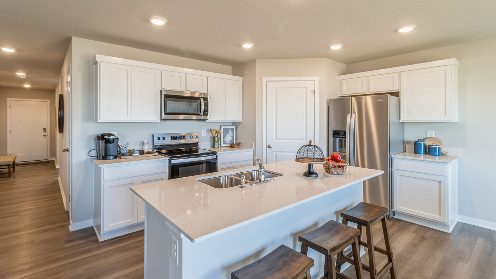 Modern kitchen with white cabinetry and stainless-steel appliances
