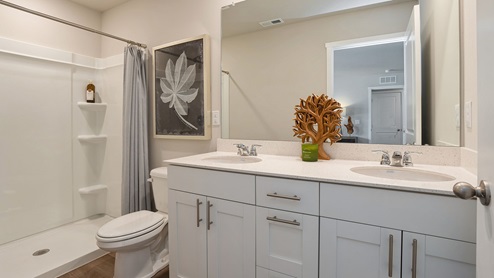 Primary bathroom with large mirror and dual sinks