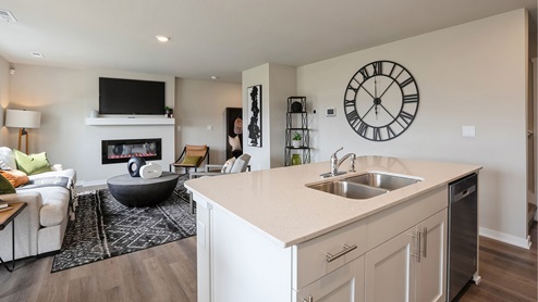 Kitchen island with dishwasher overlooking living room