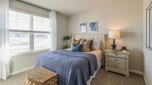 First bedroom with large window letting in lots of natural light