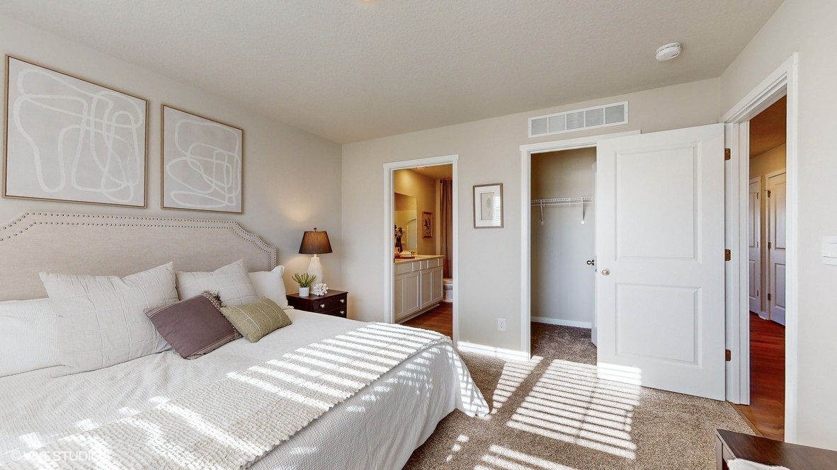 Primary bedroom showing bathroom and closet