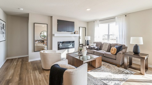 Bright Roland living room with large window and electric fireplace
