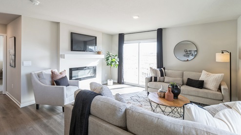 large living room with sliding glass doors and electric fireplace