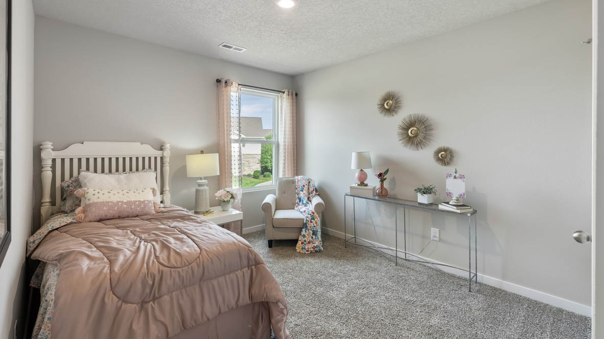 Bedroom 2 has neutral carpet and a single window.