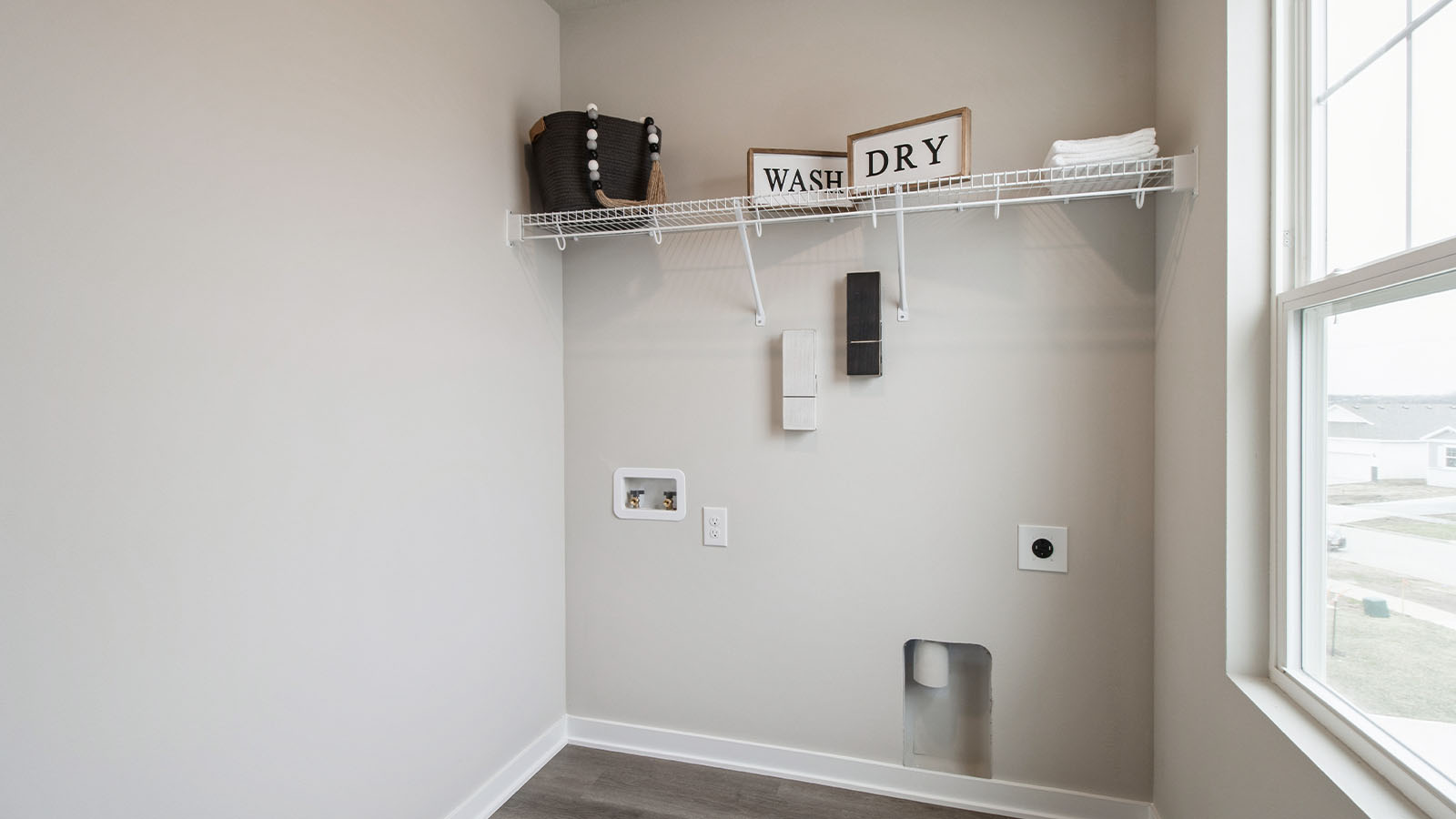 Laundry room with shelving and small window
