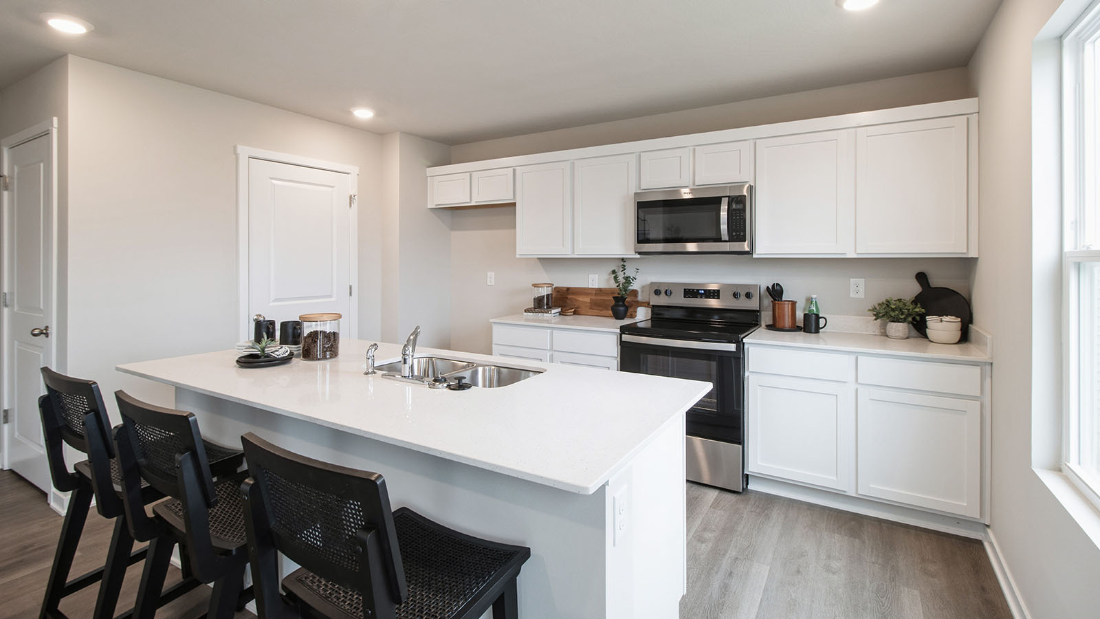Modern kitchen with white cabinetry and island with quartz countertops