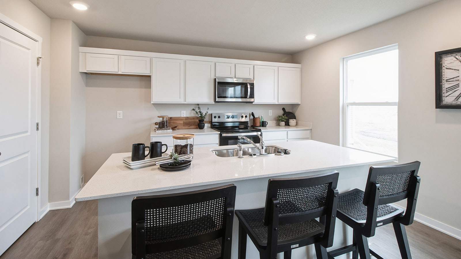 Spacious kitchen with small window and stainless-steel appliances