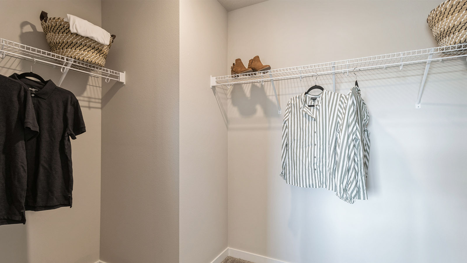Primary suite walk-in closet in Highland Meadows new home with built-in shelving and generous storage