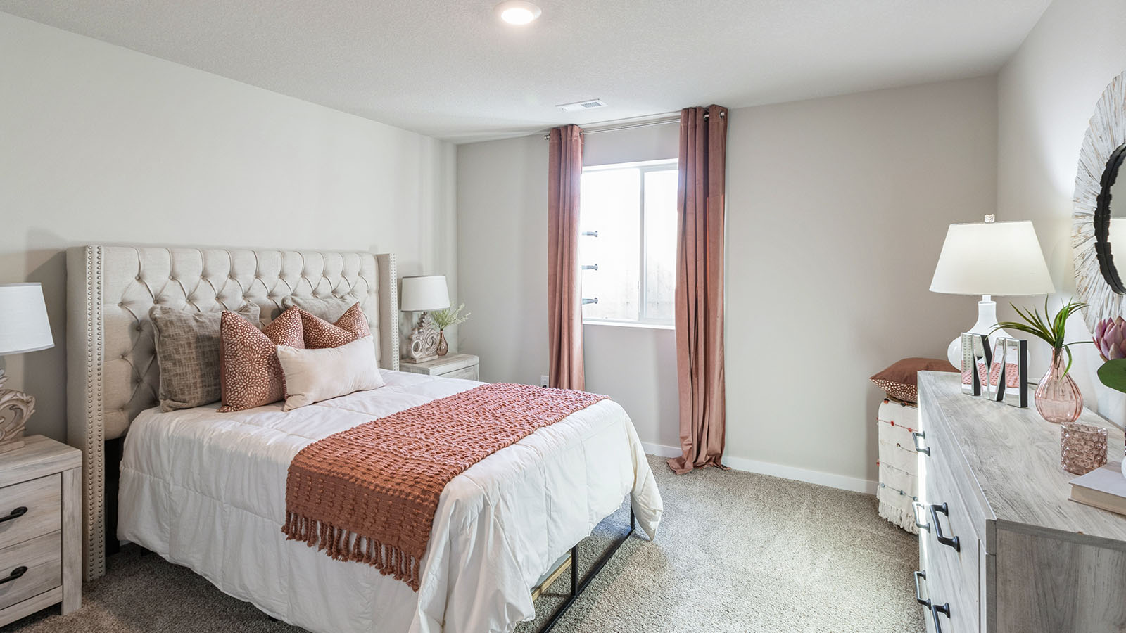 Secondary bedroom in Highland Meadows includes natural window light, full closet, connectivity to the residence