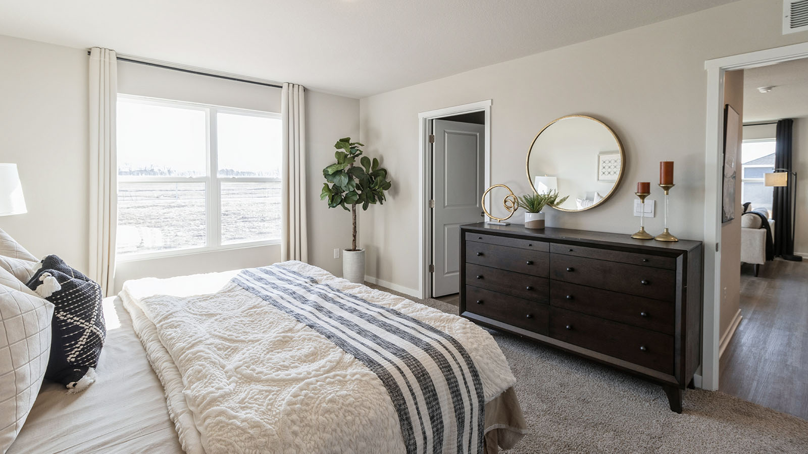 Owner’s suite offers natural window light, spa-inspired ensuite bathroom, backyard view, walk-in closet for everyday style