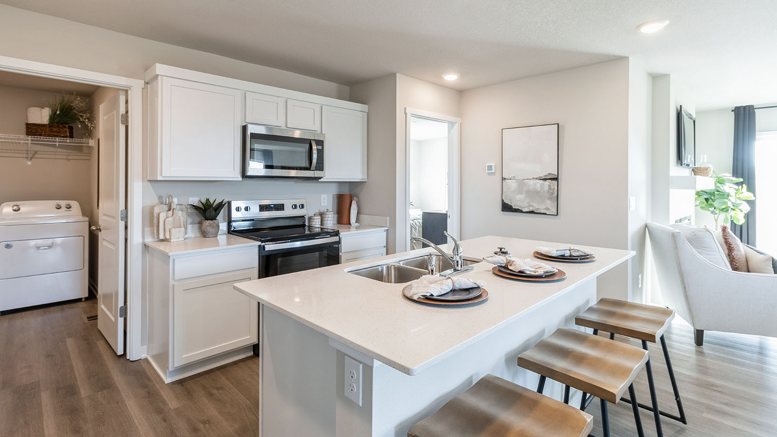 Bright white kitchen with island and quartz countertops