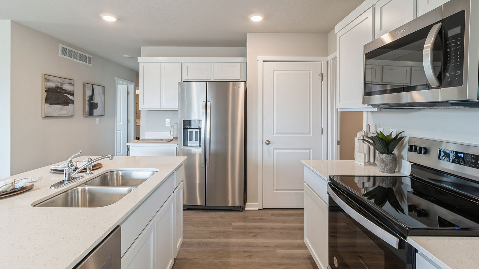 Side view of modern kitchen with island and walk-in pantry