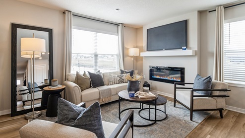 Bright living room of Pearson townhome with large window and electric fireplace