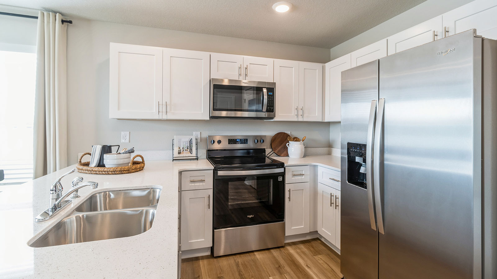 Modern kitchen with dual stainless-steel sinks and white cabinetry