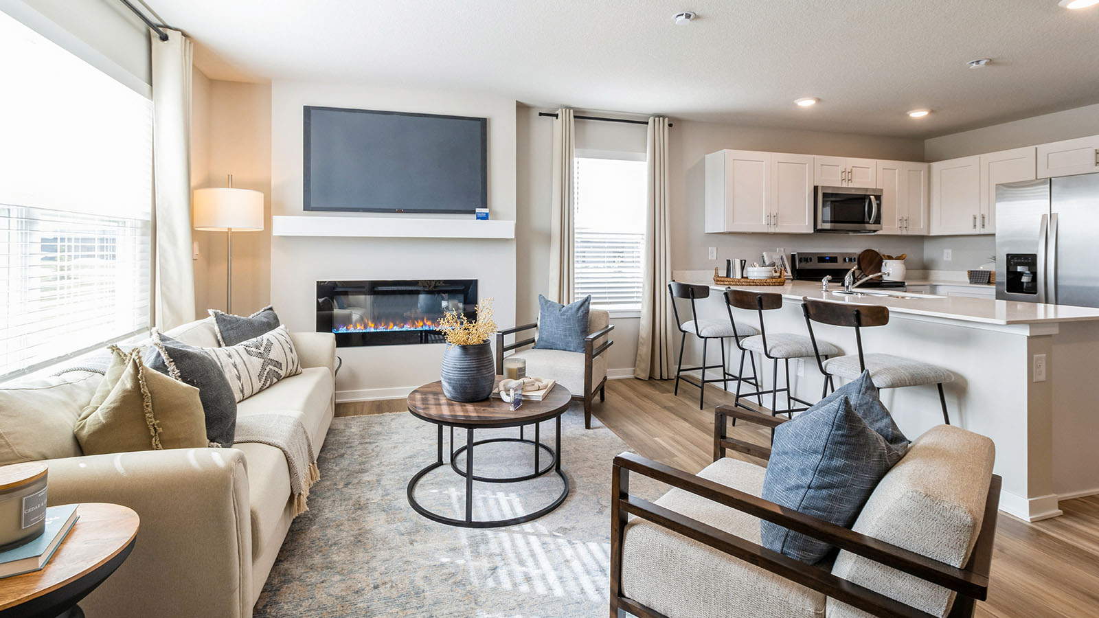 Cozy living room with a loveseat and two white chairs with a round coffee table