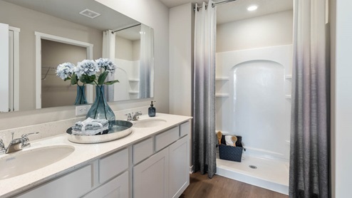 big primary bathroom with white counters and shower