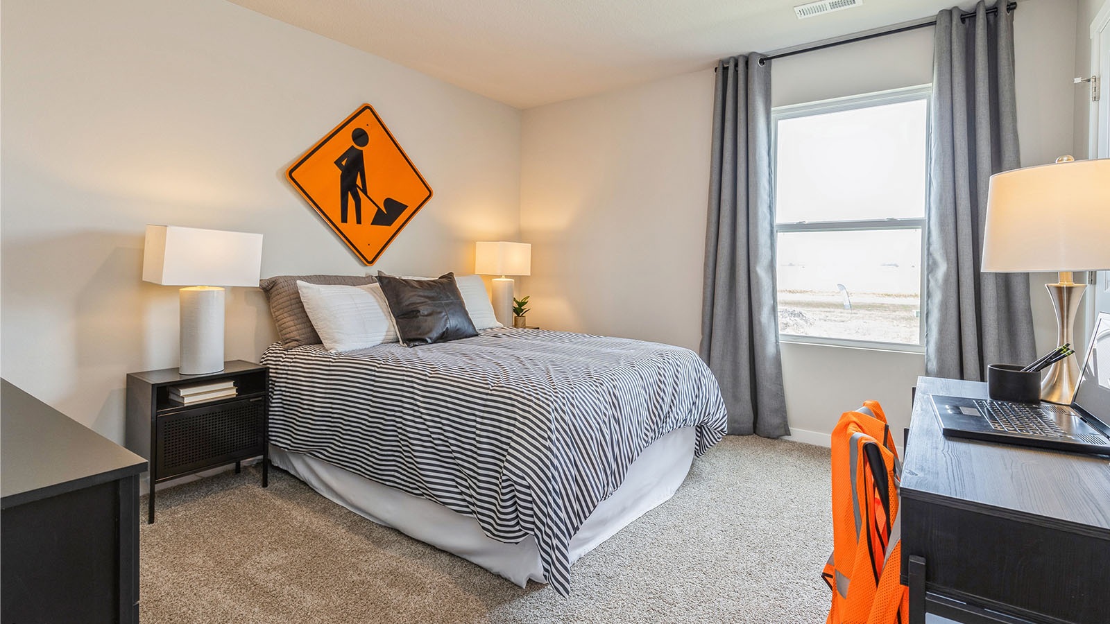 fourth bedroom with black dresser and desk