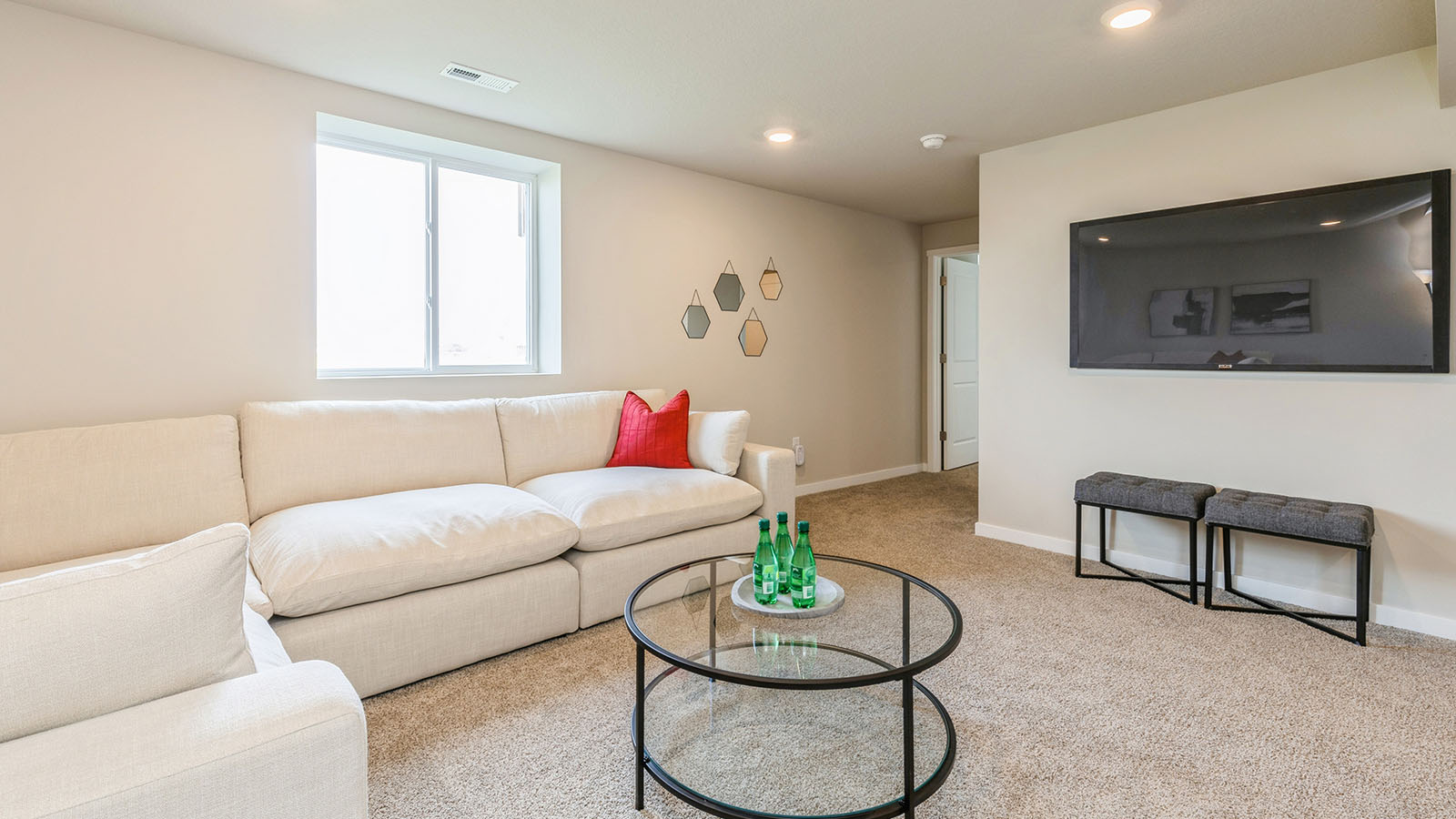 finished basement with mounted tv and coffee table