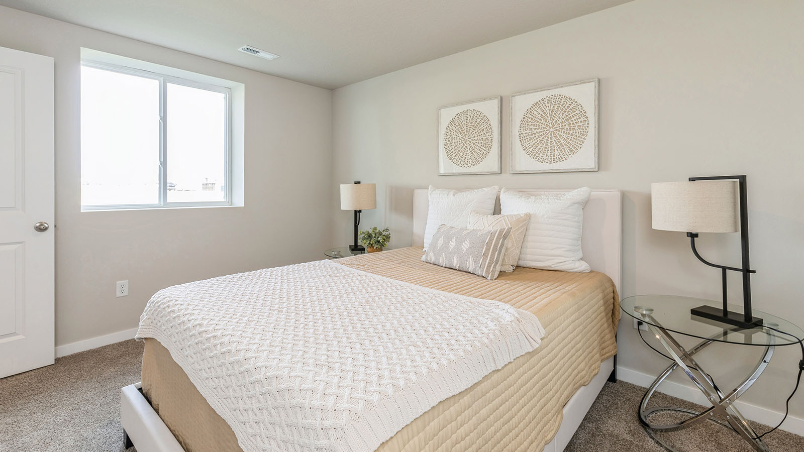 fourth bedroom with tan bed and glass nightstands