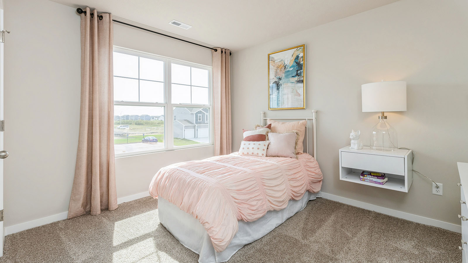 First bedroom with large window and small pink bed