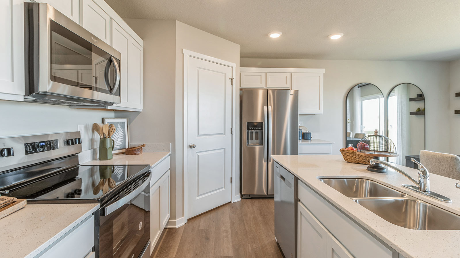 Bright and modern kitchen with walk-in pantry and island with dual sinks