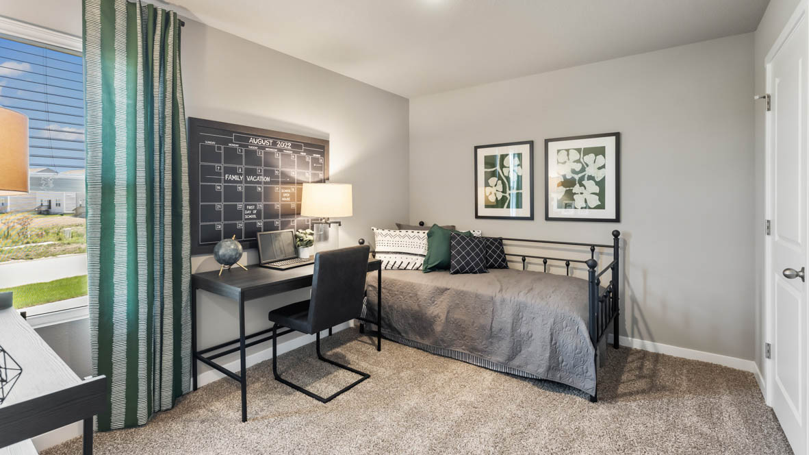 Secondary Bedroom in this Painted Woods West Townhomes showcases plush flooring, a single door closet, convenient hallway access.