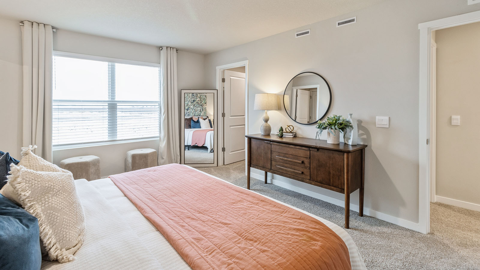 Bright and open owner's bedroom in Painted Woods West Townhomes overlooking the backyard, en-suite bathroom, Walk-in closet.