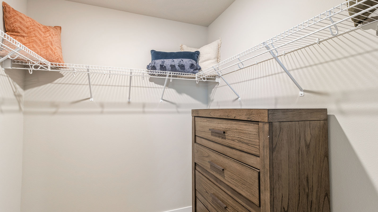 Walk-in closet directly off the primary suite in Painted Woods West Townhomes designed for modern living