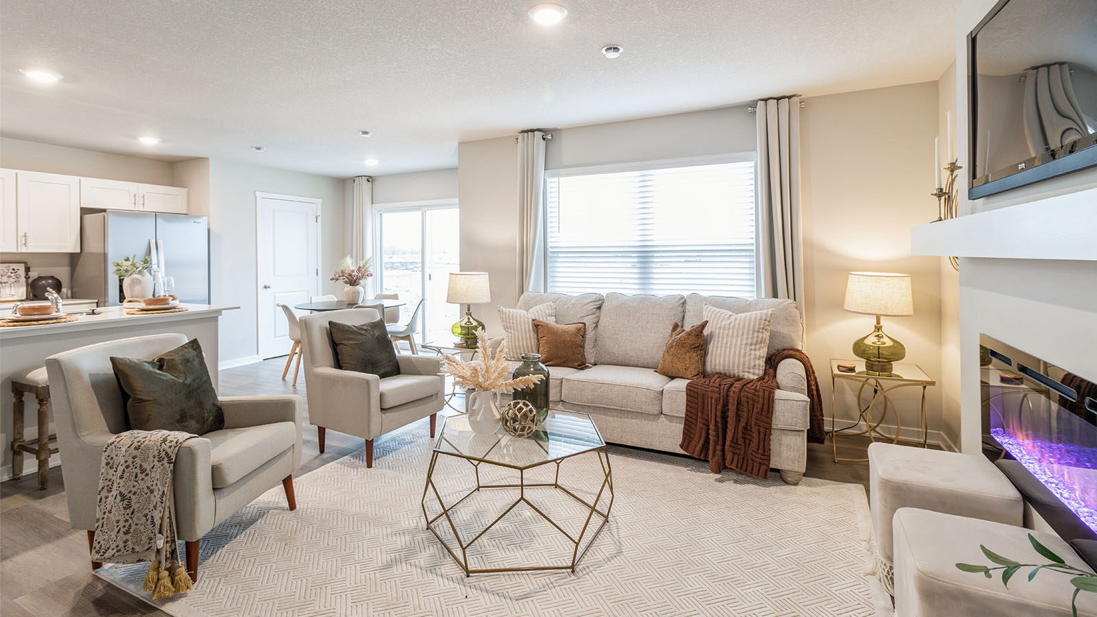 Main living zone with easy access between kitchen, dining area, and family room in Painted Woods West Townhomes