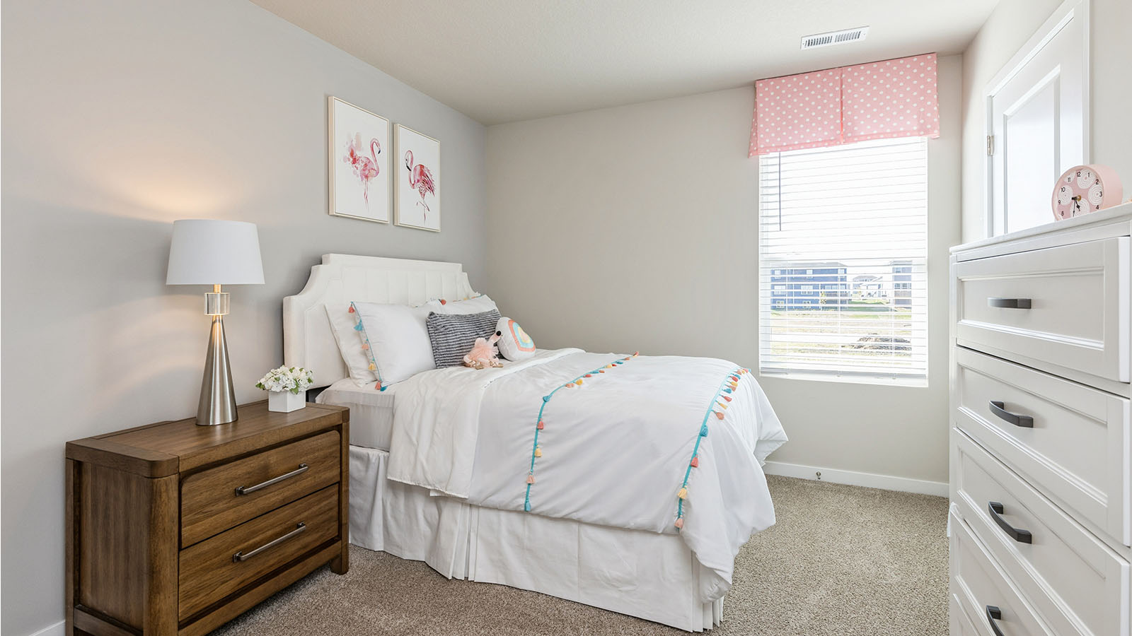 Second bedroom with white bed and a dresser