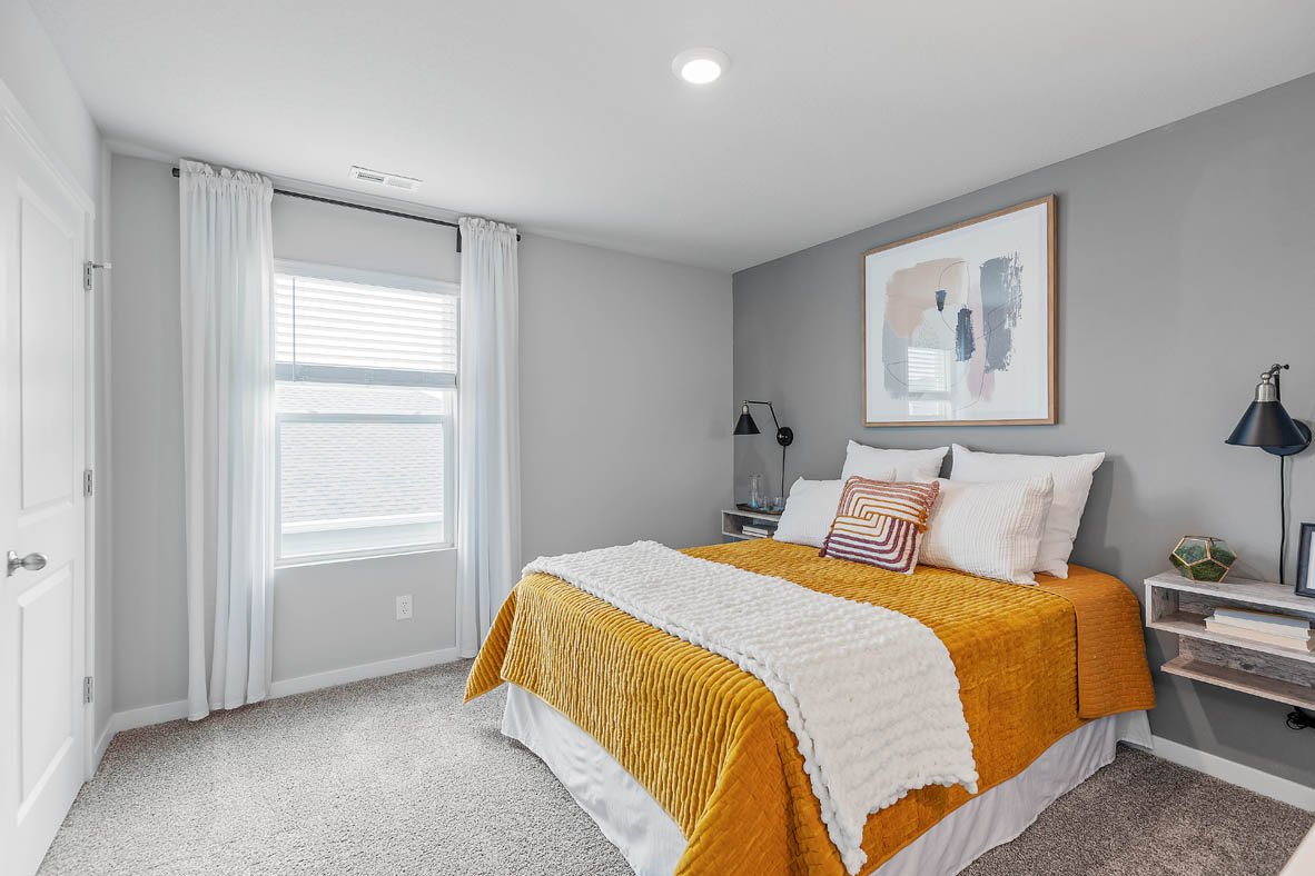 Second bedroom with window and accent wall