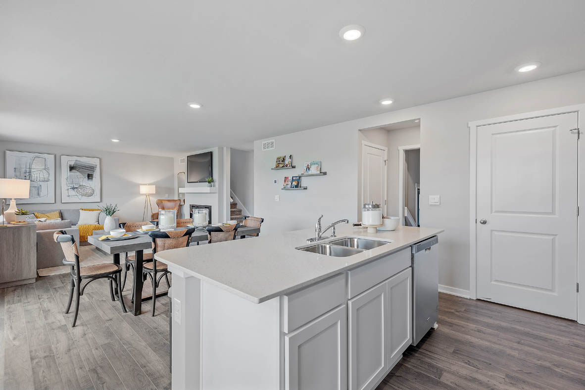 white kitchen island overlooking bright living room