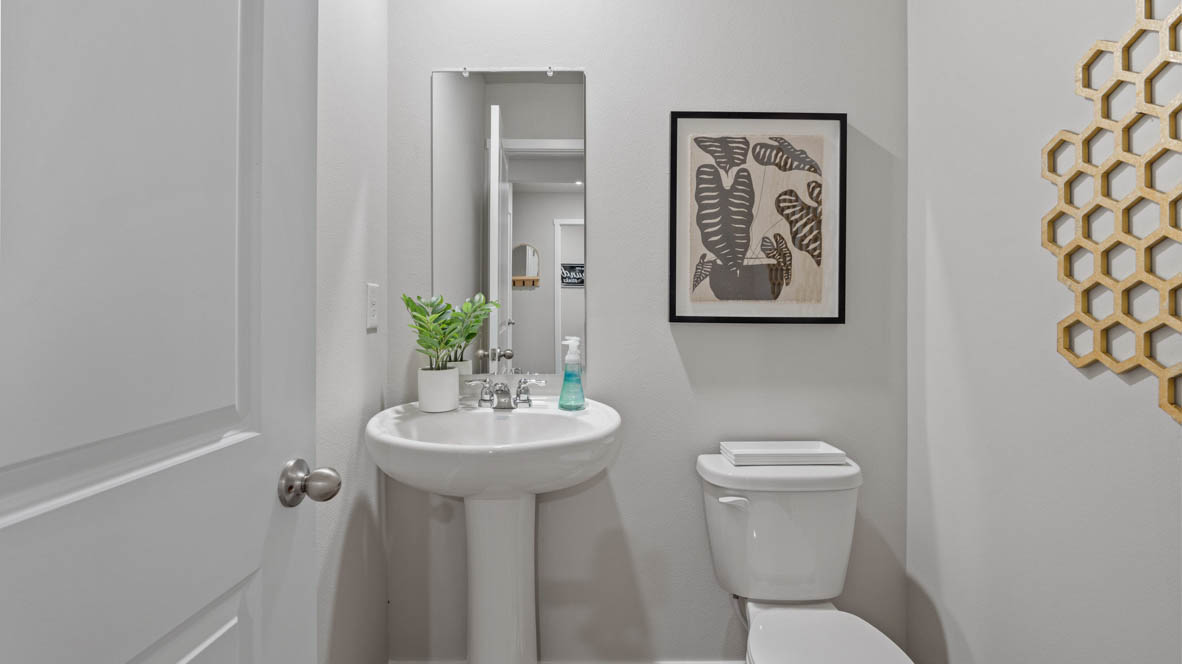 Half bathroom with sink and mirror