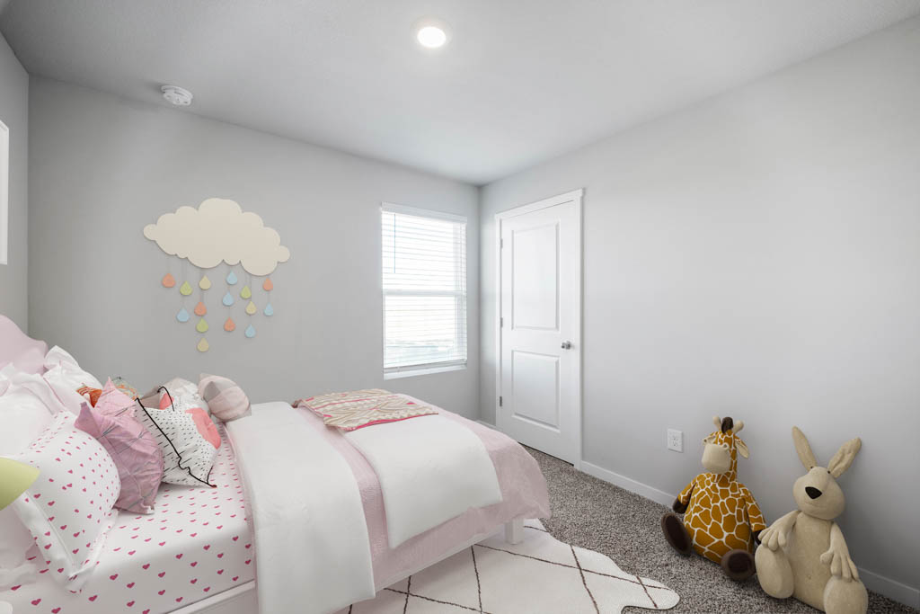 first bedroom with pink bed and window