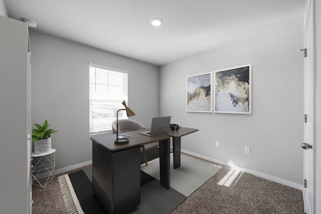 third bedroom staged as office with desk and chairs