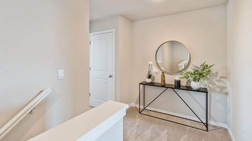 Upstairs hallway with shelving and mirror above