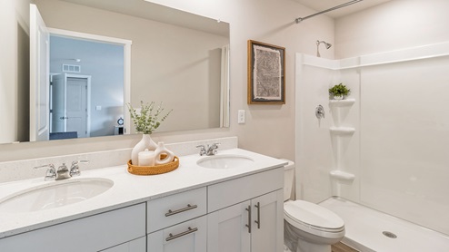 Primary bathroom with dual sinks and shower