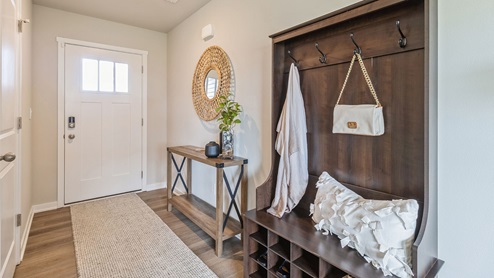 Front entryway with dark brown wood hall tree
