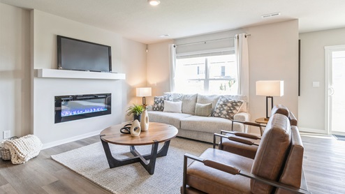 Spacious living room with large window and overhead lighting