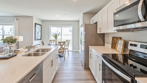 Side view of kitchen with island and dual sinks