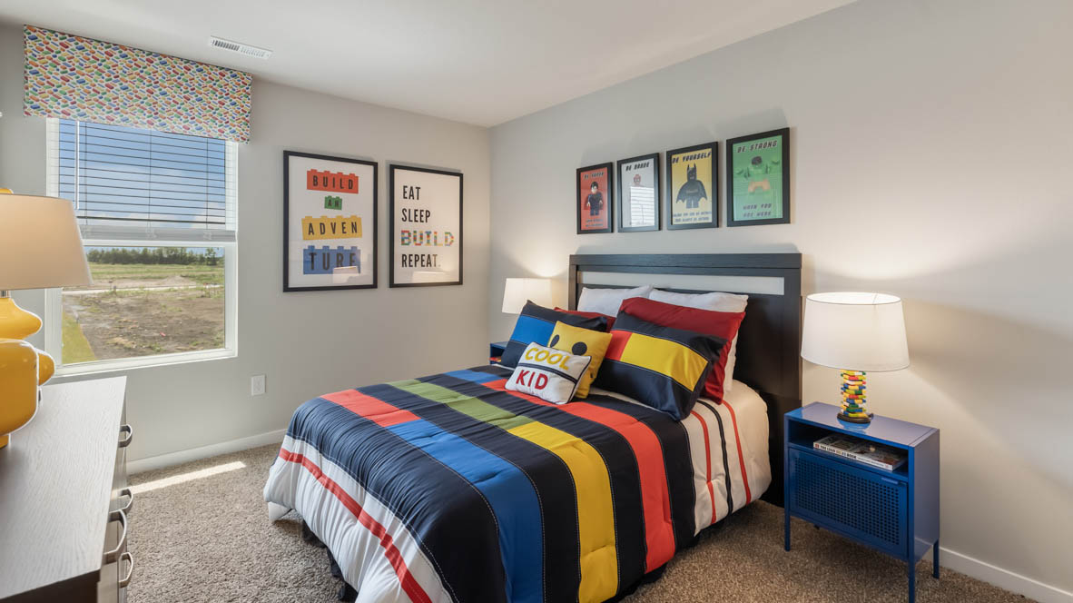 second bedroom with colorful bed and blue nightstands