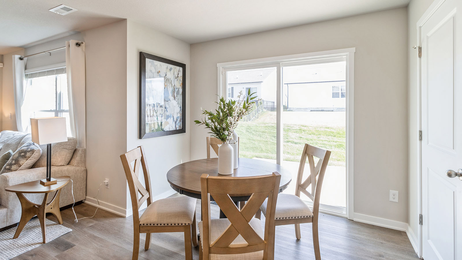 Dining area with wood dining table next to glass sliding doors