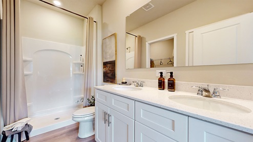 Primary bathroom with large mirror and mirror