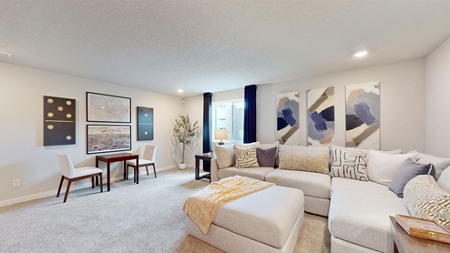 Finished basement with large white sectional