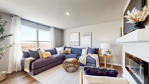 open concept living room with large window and overhead lighting