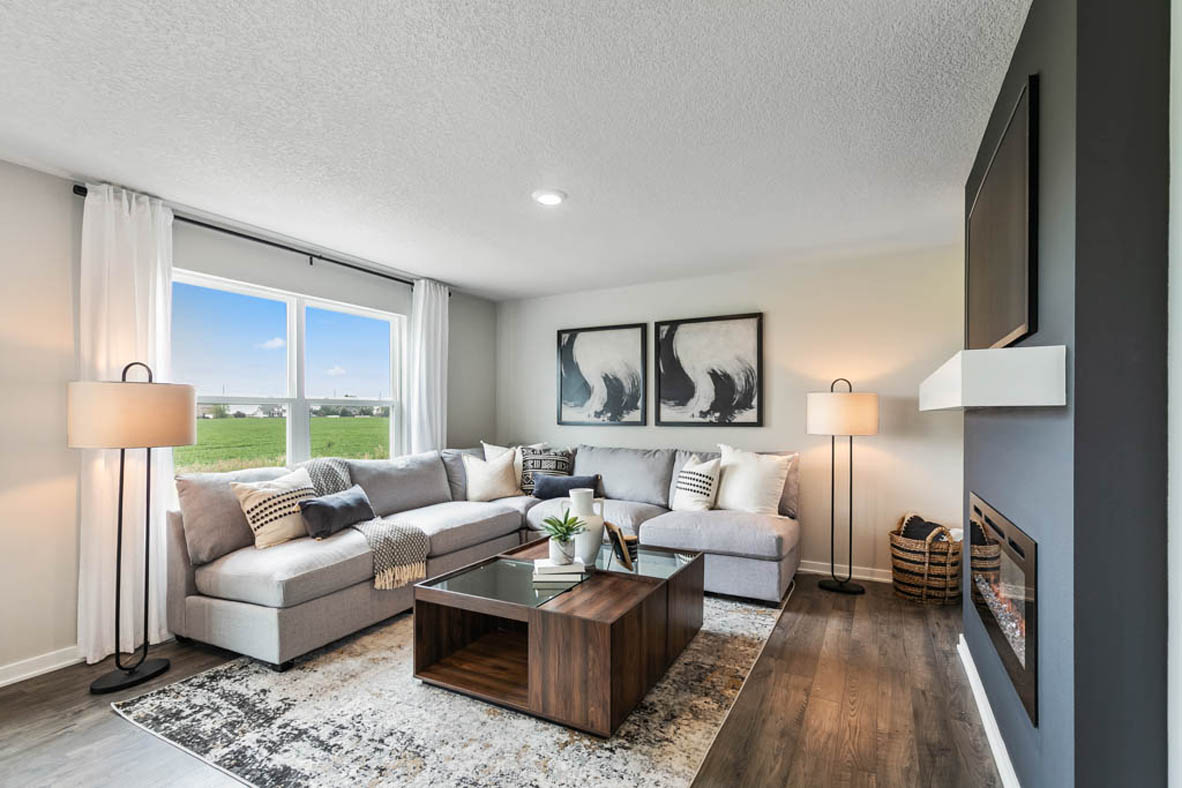 Living room of the Bellhaven plan with a large window overlooking the back yard.
