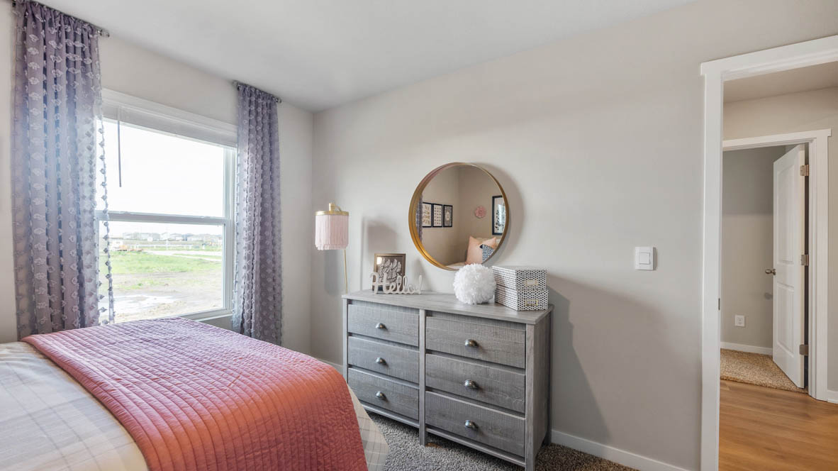 The Hamilton plan's secondary bedroom with a window looking out of the side of the home.