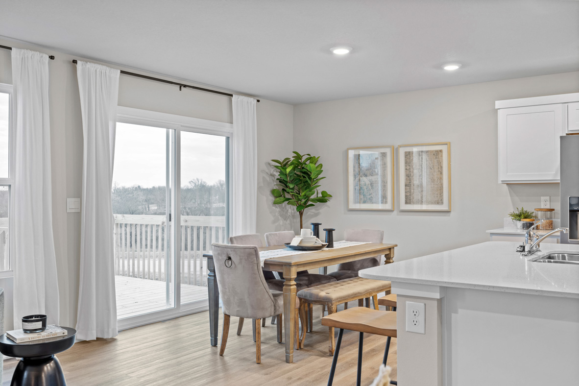 A view of the dining area off of the kitchen with sliding doors that provide access to the back deck.